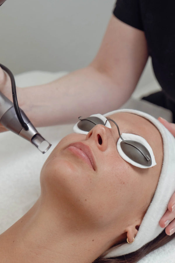 Person receiving a facial treatment with a device on their face.